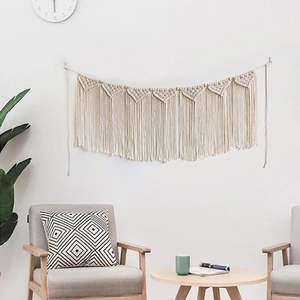 Bohemian macrame wall hanging with cotton rope tassels for home decor on white wall