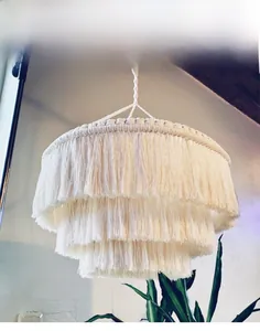 Detail of multi-layered hand-woven tassel lampshade with bohemian cotton fringe textures