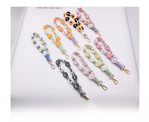 Detail of colorful hand-woven crochet flower wristlets with gold metal lobster clasps