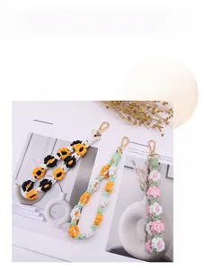 Detail of handmade woven flower phone charms with golden lobster clasps in various colors