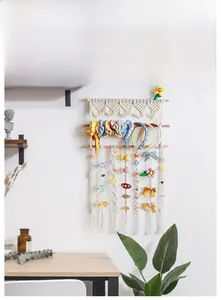 Detail view of woven cotton rope wall organizer for hair accessories in Boho style