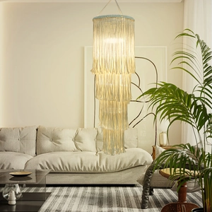 Detail of four-tier boho macrame lampshade with handwoven tassels and soft warm light