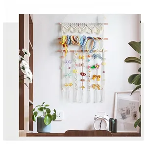 Detail of bohemian woven cotton hair accessory wall organizer with floral lace accents