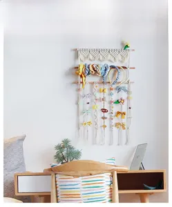Bohemian woven cotton wall organizer for hair accessories with wooden poles and hairpins