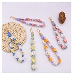Macro shot of colorful hand-woven flower charms with durable golden lobster clasps