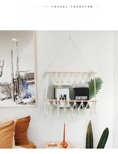 Close-up of bohemian hand-woven cotton wall organizer with tassel and wooden stick
