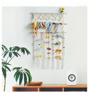 Detail view of woven cotton tapestry storage for hair clips and headbands with wood support