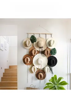 Detail of bohemian hand-woven cotton macrame hat organizer with tassels and wood pole