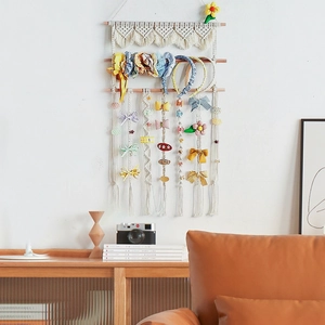 Handmade boho macrame cotton hair accessory wall organizer with wooden bars and fringe