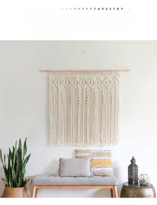 Close-up of bohemian hand-woven cotton tapestry with tassel details on a wooden rod