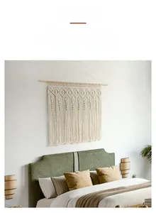 Detail of bohemian macrame tapestry with handmade geometric patterns and cotton tassels