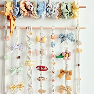 Handwoven boho wall hanging hair accessory organizer with cotton rope and wooden rods
