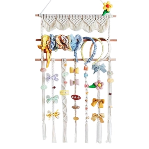 Handwoven macrame wall hanging organizer for hair clips and bows in boho nursery style