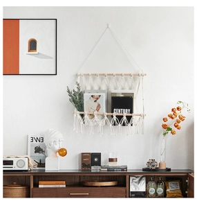 Detail of hand-woven bohemian magazine rack with natural cotton rope and wooden rods