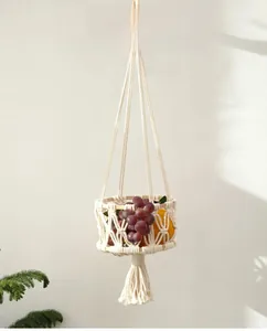 Detail of bohemian cotton rope fruit basket with handmade weaving and tassel fringe