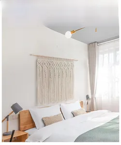 Close-up of bohemian handmade macrame wall hanging with intricate cotton fringe details