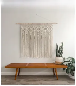 Close-up of Bohemian hand-woven macrame wall hanging with intricate geometric knots and tassels