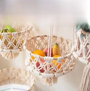 Detail of bohemian handmade cotton rope fruit basket with woven texture and tassels