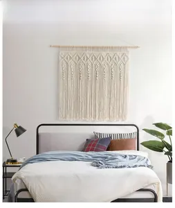 Detailed close-up of Bohemian hand-woven cotton tapestry with diamond patterns and tassels