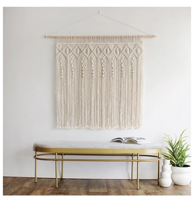 Detailed close-up of macrame wall hanging with woven diamond patterns and fringe tassels