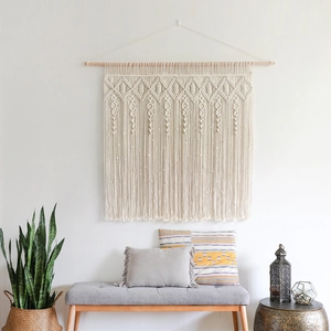 Bohemian handmade macrame wall hanging with geometric patterns and fringe for home decor
