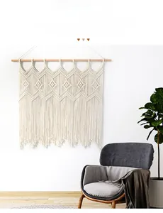 Detail of bohemian hand-woven cotton tapestry with geometric patterns and fringe tassels