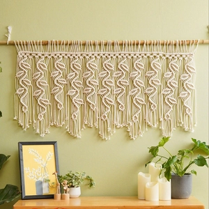 Detailed macro view of bohemian hand-woven cotton macrame with intricate leaf patterns