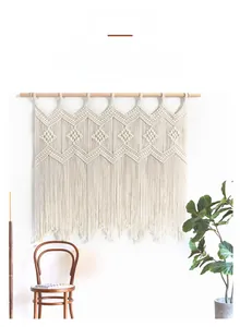 Detailed view of hand-woven bohemian tapestry with geometric patterns and long tassels