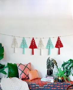 Detail of macrame Christmas tree wall hanging with cotton ropes and wooden beads