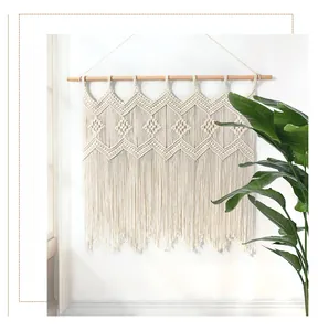 Close-up of bohemian hand-woven macrame tapestry with diamond patterns and fringe