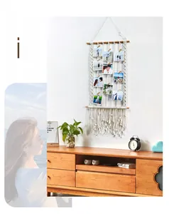 Detailed close-up of handmade macrame wall hanging with wooden clips for photo display