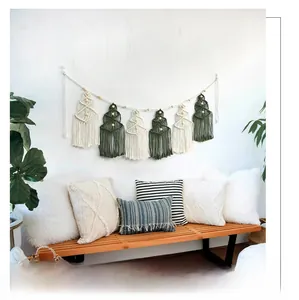 Detail of macrame Christmas tree wall hanging with wooden beads and boho fringe