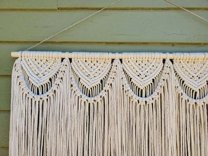Detailed close-up of handmade Bohemian macrame wall hanging with intricate cotton knots