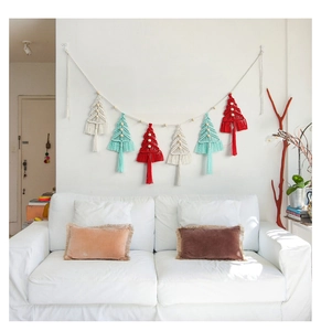 Detail of handcrafted macramé Christmas tree banner with festive cotton fringe and wood beads