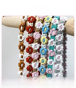 Macro shot of colorful handmade crochet daisy flower straps in soft cotton rope