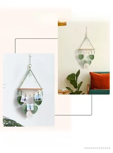 Detail of handmade woven leaf tapestry rack with wooden beads and photo clips