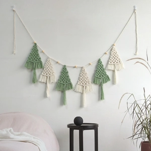 Handwoven macrame Christmas tree wall hanging with tassels in bohemian interior style