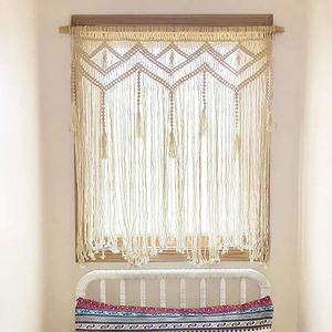 Handwoven Bohemian macrame door curtain with geometric patterns and tassel fringe
