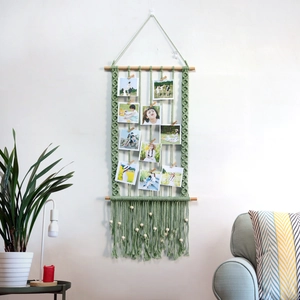 Boho sage green macrame wall hanging photo display with wooden clips and fringe
