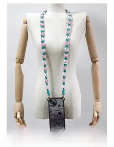 Close-up of hand-woven daisy flower lanyard strap for phone and bags in pink and green