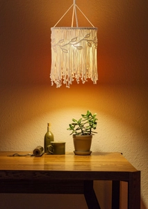 Detailed macro view of the bohemian macramé lampshade with leaf texture and fringe