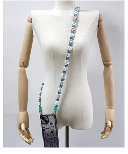 Detail of hand-woven daisy flower lanyard on a glitter phone case with bear pattern