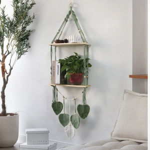 Detail of bohemian woven wall shelf with green cotton rope and wooden tiers
