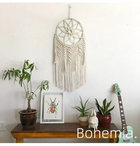 Close-up of bohemian woven cotton wall hanging with star pattern and elegant tassels