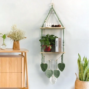 Detailed view of bohemian double-layer macrame wall shelf with woven leaf charms
