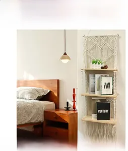 Close-up of bohemian hand-woven macrame wall shelf with three-tier wood layers and tassels
