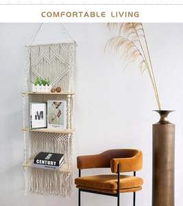 Detail of bohemian hand-woven macrame wall shelf with heart patterns and wooden boards