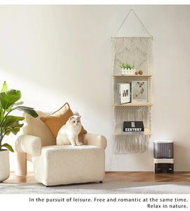 Close-up of three-tier macrame wall hanging shelf with cotton rope and wood boards