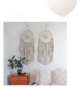 Detailed handmade bohemian macramé dream catcher wall hanging with cotton tassels