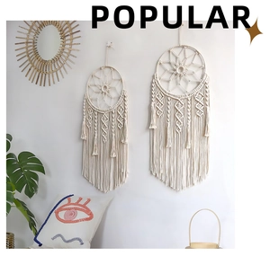 Detail of bohemian macrame dreamcatcher wall hanging with handmade cotton rope weaving